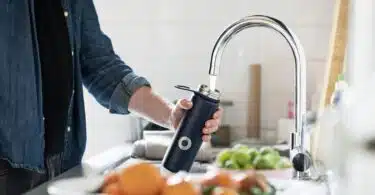 person holding stainless steel faucet